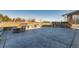 A backyard with a stone firepit, built-in BBQ, and a spacious patio area for entertaining at 15102 Prairie Pl, Broomfield, CO 80023
