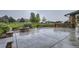 An outdoor stone kitchen, fire pit and plush lawn in the fenced backyard for entertaining at 15102 Prairie Pl, Broomfield, CO 80023
