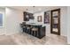 Basement bar area with seating, wine storage, and pendant lighting at 15102 Prairie Pl, Broomfield, CO 80023
