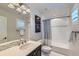 Bathroom with a single vanity, framed mirror, subway tile shower and baseball-themed decor at 15102 Prairie Pl, Broomfield, CO 80023