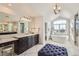 Spacious bathroom with double sinks, a soaking tub by a large window, and a separate vanity area at 15102 Prairie Pl, Broomfield, CO 80023