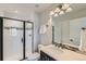 Modern bathroom with white subway tiles, a frameless shower, and granite vanity at 15102 Prairie Pl, Broomfield, CO 80023