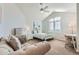 Bright bedroom featuring a couch and a large window with shutter blinds at 15102 Prairie Pl, Broomfield, CO 80023