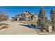 Two-story home with stone facade and landscaped yard at 15102 Prairie Pl, Broomfield, CO 80023