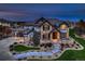 Beautiful two-story home with stone accents, manicured lawn, and inviting stone walkway leading to the front door at 15102 Prairie Pl, Broomfield, CO 80023