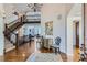 Grand foyer with hardwood floors, staircase, and elegant decor at 15102 Prairie Pl, Broomfield, CO 80023