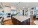 Kitchen with island, stainless steel appliances, and view to staircase and living area at 15102 Prairie Pl, Broomfield, CO 80023