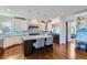 Modern kitchen with white cabinets, a large island, and blue tile backsplash at 15102 Prairie Pl, Broomfield, CO 80023