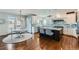 Bright kitchen with white cabinetry, stylish backsplash, and island with seating at 15102 Prairie Pl, Broomfield, CO 80023