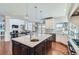 Bright kitchen with island, modern appliances, and seamless open floor plan to the living room at 15102 Prairie Pl, Broomfield, CO 80023