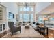 Open-concept living room with large windows, built-in shelving, and ample seating at 15102 Prairie Pl, Broomfield, CO 80023