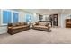 Spacious living room with neutral carpet, stylish seating, and large, bright windows at 15102 Prairie Pl, Broomfield, CO 80023