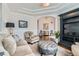 Cozy living room with neutral tones and arched doorway at 15102 Prairie Pl, Broomfield, CO 80023