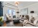 Cozy living room featuring plush seating, tray ceiling, and modern decor at 15102 Prairie Pl, Broomfield, CO 80023