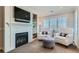 Sitting area with fireplace, built-in shelving and comfortable chairs at 15102 Prairie Pl, Broomfield, CO 80023