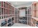 Climate controlled wine cellar with custom wooden racks and lighting at 15102 Prairie Pl, Broomfield, CO 80023