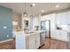 Stylish kitchen with white cabinetry, stainless appliances, and a large island at 400 E Fremont Pl # 207, Centennial, CO 80122