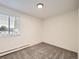 Clean bedroom features neutral carpet, baseboard heat and a window at 750 S Clinton St # 2C, Denver, CO 80247