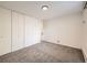 Bedroom featuring neutral carpet and a spacious closet with sliding doors at 750 S Clinton St # 2C, Denver, CO 80247