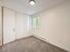 Bright bedroom with neutral carpet, closet and a large sunny window at 750 S Clinton St # 2C, Denver, CO 80247