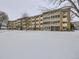 Apartment building exterior showcasing its snow covered lawn at 750 S Clinton St # 2C, Denver, CO 80247