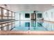 Bright indoor pool with clear water, large windows, and easy access via steps and ladder at 750 S Clinton St # 2C, Denver, CO 80247