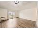 Spacious living room with wood floors and access to a balcony at 750 S Clinton St # 2C, Denver, CO 80247