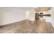 Open-concept living area connecting to a modern kitchen with hardwood floors at 750 S Clinton St # 2C, Denver, CO 80247