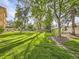 Scenic view of community green space with mature trees and lush lawn at 750 S Clinton St # 2C, Denver, CO 80247