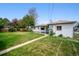 View of the backyard with well maintained lawn and patio at 8020 W 46Th Cir, Wheat Ridge, CO 80033