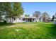 View of the backyard with well maintained lawn and patio at 8020 W 46Th Cir, Wheat Ridge, CO 80033