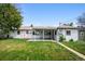 View of the backyard with well maintained lawn and patio at 8020 W 46Th Cir, Wheat Ridge, CO 80033