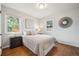 Bedroom featuring hardwood floors, natural light, and neutral decor, creating a cozy atmosphere at 8020 W 46Th Cir, Wheat Ridge, CO 80033