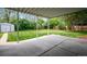 View of the covered patio looking out to backyard, showcasing lush greenery, lawn, and an outdoor storage shed at 8020 W 46Th Cir, Wheat Ridge, CO 80033