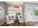 Charming dining area with hardwood floors, a glass-top table, upholstered chairs, and soft lighting at 8020 W 46Th Cir, Wheat Ridge, CO 80033
