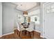 Well-lit dining area featuring a glass-top table, comfortable seating, hardwood floors, and access to the outdoors at 8020 W 46Th Cir, Wheat Ridge, CO 80033