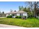 Well-maintained single-Gathering home with green lawn, mature trees, and landscaped front yard. Lawn has lush green grass at 8020 W 46Th Cir, Wheat Ridge, CO 80033