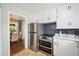 Bright kitchen featuring stainless steel appliances, white cabinets, and a view into the dining room at 8020 W 46Th Cir, Wheat Ridge, CO 80033