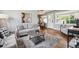 Cozy living room featuring hardwood floors, a soft rug, neutral seating arrangements, and an inviting atmosphere at 8020 W 46Th Cir, Wheat Ridge, CO 80033