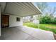 Covered patio and backyard with convenient access to the house and well-manicured lawn at 8020 W 46Th Cir, Wheat Ridge, CO 80033