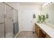 Bright bathroom with a glass enclosed shower, modern vanity, and neutral toned walls and floors at 23625 E Kettle Pl, Aurora, CO 80016