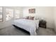 Well-lit bedroom featuring a serene color palette, comfortable bedding, and mountain-themed artwork at 23625 E Kettle Pl, Aurora, CO 80016