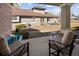 Inviting covered patio with comfortable seating and a view of the well-maintained landscaping at 23625 E Kettle Pl, Aurora, CO 80016