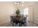 Bright dining area with a marble table, modern chandelier, and access to outdoor patio at 23625 E Kettle Pl, Aurora, CO 80016