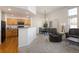 Bright living space featuring a kitchen view, dining area, and comfortable seating under tall windows at 23625 E Kettle Pl, Aurora, CO 80016