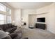 Cozy living area with neutral palette, large windows, and a doorway view into the bedroom at 23625 E Kettle Pl, Aurora, CO 80016