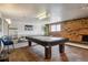 Cozy billiards room with brick accent wall and plenty of space for game at 625 N Pennsylvania St # 208, Denver, CO 80203