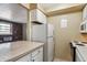 Cozy kitchen with white appliances, tile counters, and warm-toned walls at 625 N Pennsylvania St # 208, Denver, CO 80203