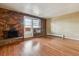 Apartment living room with brick accent wall, fireplace, and hardwood floors at 625 N Pennsylvania St # 208, Denver, CO 80203