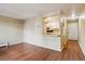Open concept apartment living room open to kitchen, with hardwood floors at 625 N Pennsylvania St # 208, Denver, CO 80203